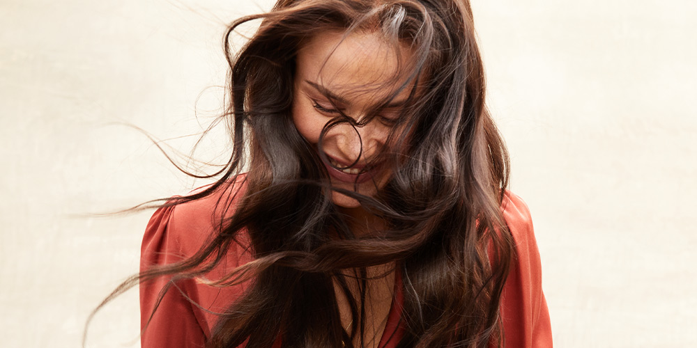 woman smiling with wind blowing hair